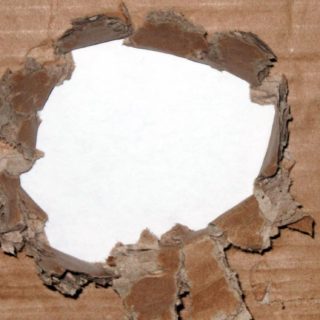 Torn cardboard brown hole iPhone5s / iPhone5c / iPhone5 Wallpaper